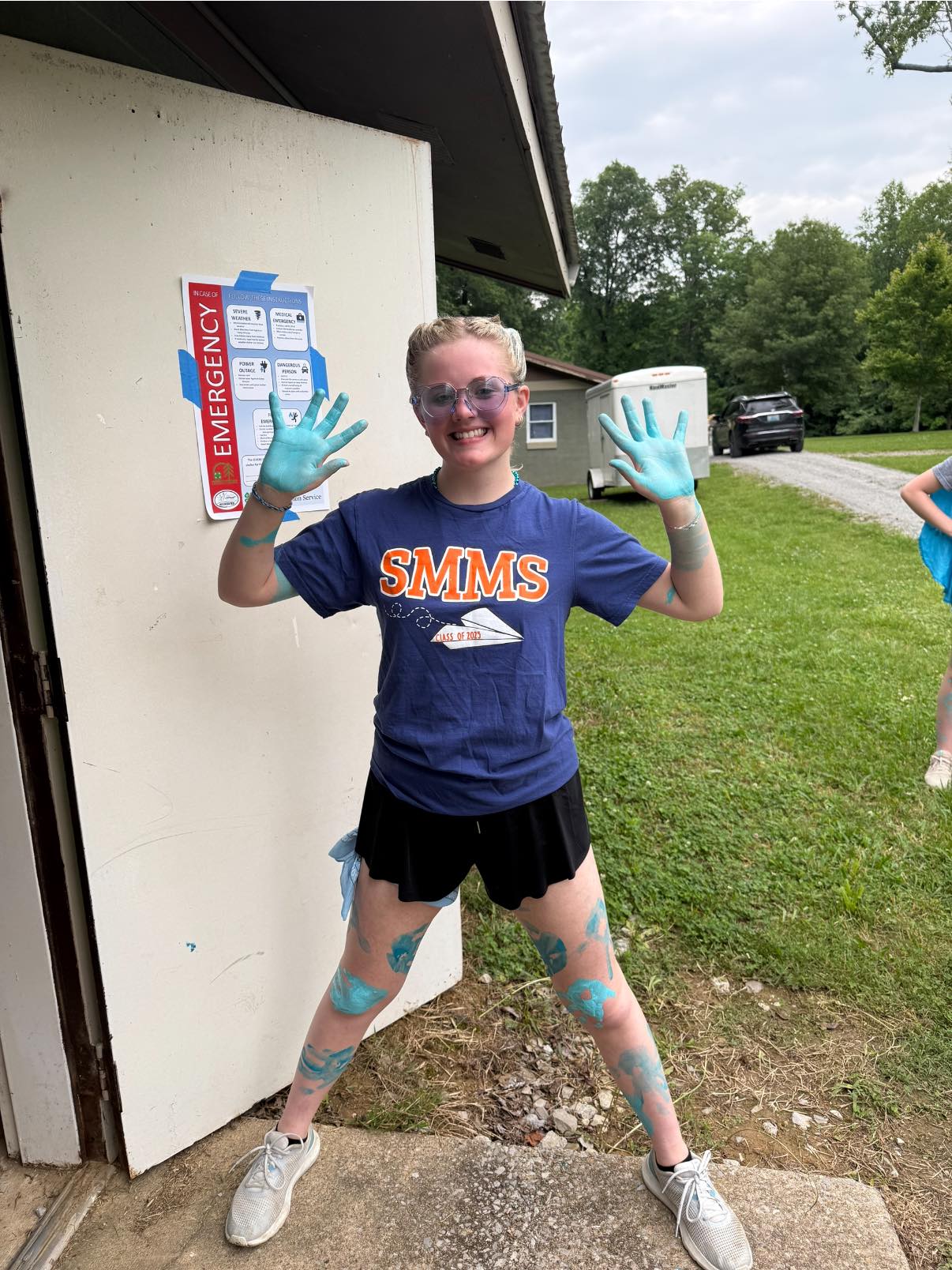 Girl with blue paint all over hands