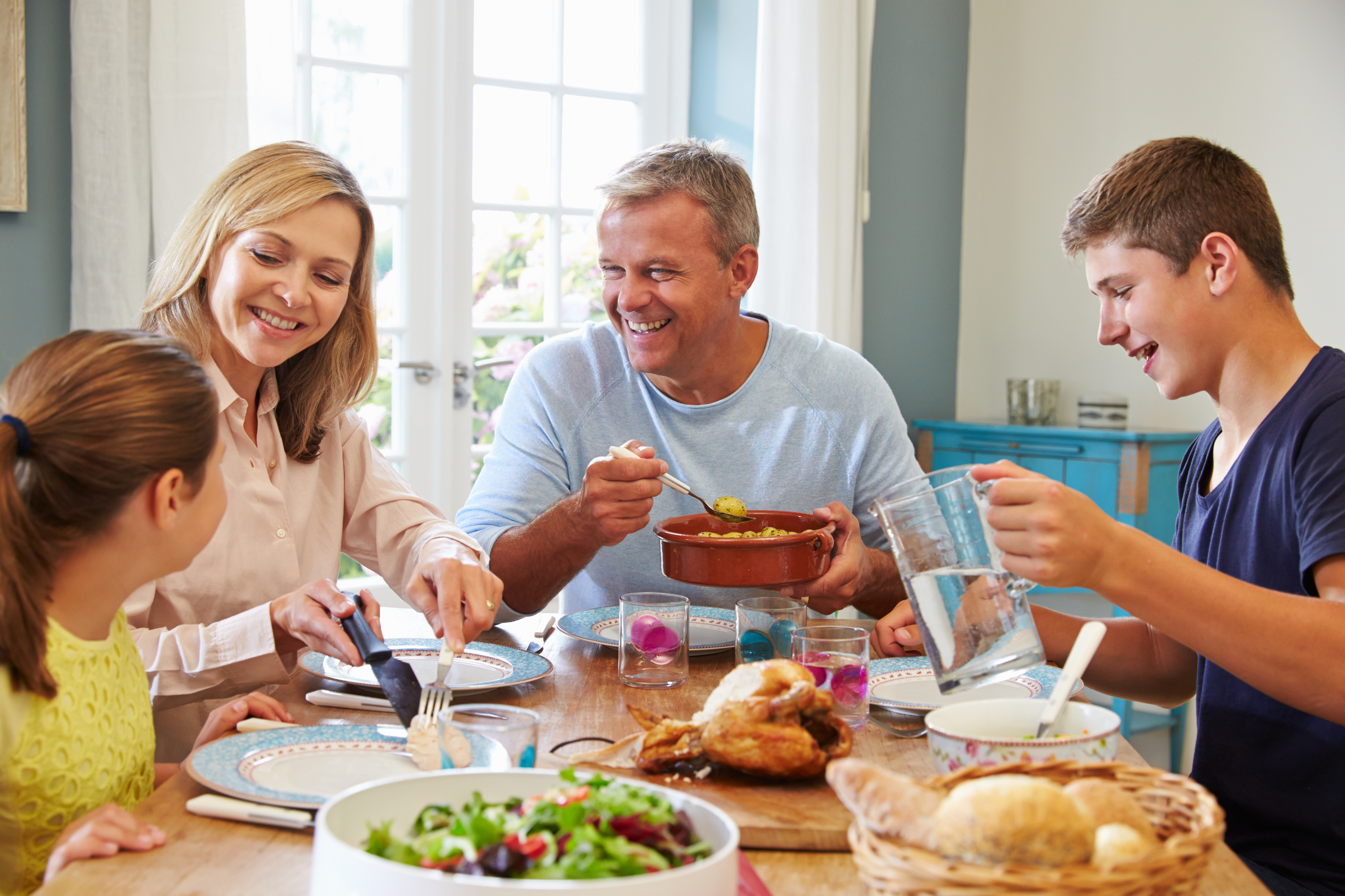 Family Enjoying Meal At Home Together